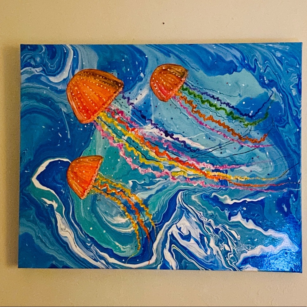 Three colorful jellyfish floating in the deep blue